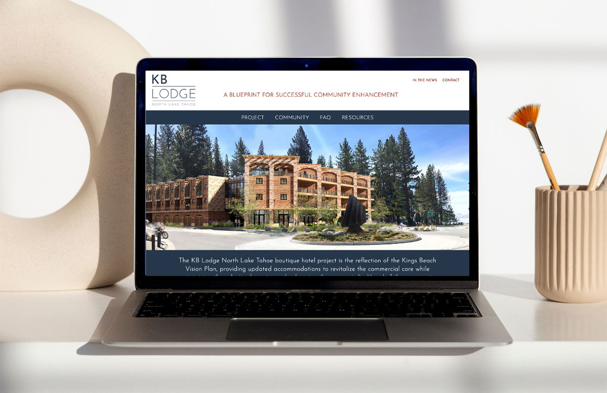 KB Lodge website featured on a laptop on a sparsely decorated desk