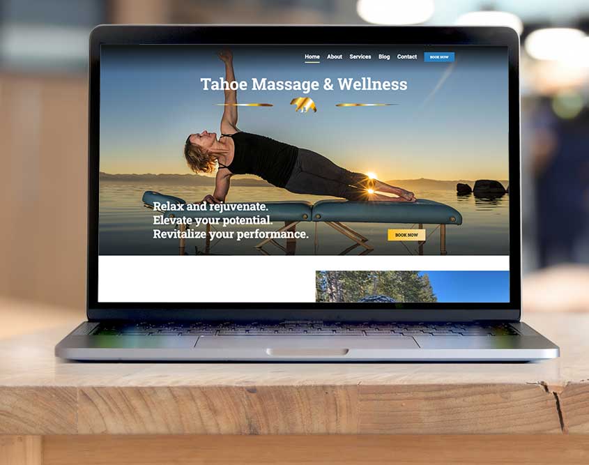 computer on a table with tahoe massage and wellness website on screen