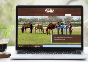 ok corral series website on a laptop with coffee next to it