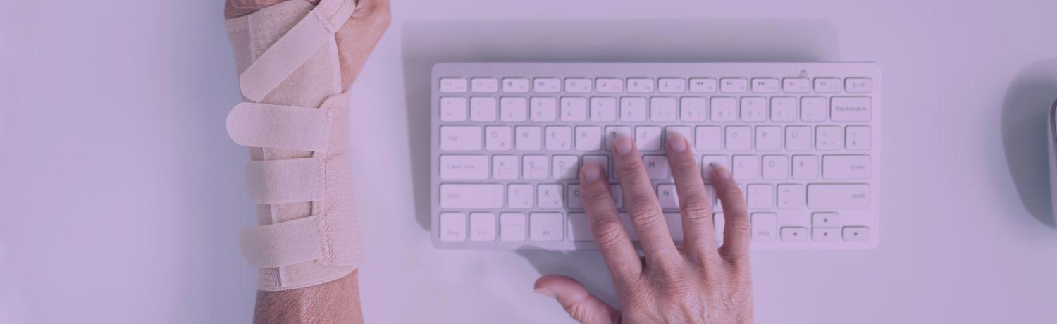 Computer user with sprained left hand typing with right hand